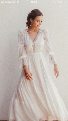 a woman in a white dress standing on a wooden floor