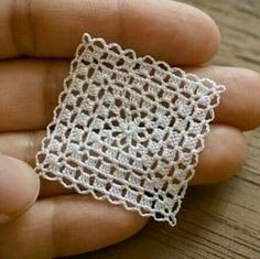 someone is holding a small piece of crochet