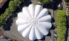 an aerial view of a large white object in the middle of a parking lot