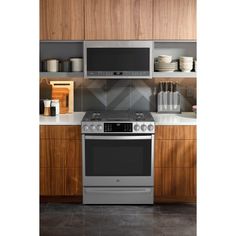 a stainless steel stove and microwave in a kitchen