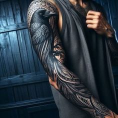 a man with tattoos on his arm and shoulder