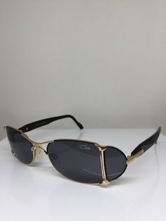 Vintage Cazal 998 Sunglasses Frames - NOS - M. 998 Col. 302 Black & Gold Germany New Vintage Classic Cazal 998 Sunglasses Frames With Side Shields/Lenses Model/Style: 998 Color: Col. 302, Black & Gold with Design Accents & Detailing on Frames & Temples Lenses: Solid Grey Size: 48-18-135 mm NOS-New Old Stock Made in Germany All Sales Final No Returns Modern Metal Frame Sunglasses For Formal Occasions, Formal Rimless Sunglasses With Metal Frame, Vintage Aviator Sunglasses With Gradient Lenses For Formal Occasions, Vintage Aviator Sunglasses With Gradient Lenses For Formal Events, Modern Shield Sunglasses With Mirrored Lenses For Formal Occasions, Black Rimless Sunglasses For Formal Occasions, Formal Black Sunglasses With Metal Frame, Modern Polarized Shield Sunglasses For Formal Occasions, Classic Aviator Sunglasses With Uva Protection For Formal Occasions