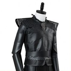 a black leather outfit with cutouts on the chest and shoulder, made to look like an armor