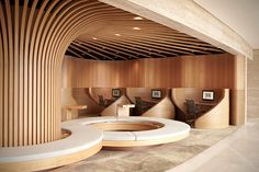 an office with curved wooden walls and benches in the center, as well as round seating