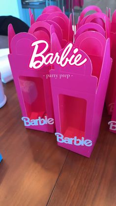 pink barbie party bags on a wooden table