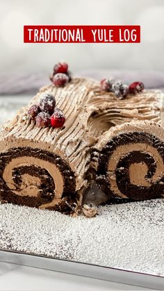 there is a chocolate log cake with cranberries on the top and frosting