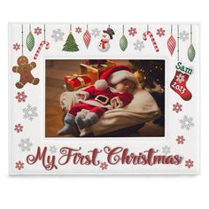 a christmas photo frame with a santa clause holding a baby