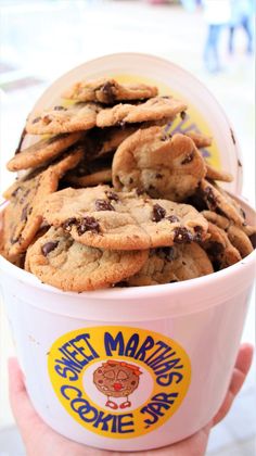 a cup filled with chocolate chip cookies on top of a table