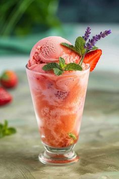 a glass filled with ice cream and strawberries