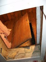 an open wooden box sitting in the corner of a room