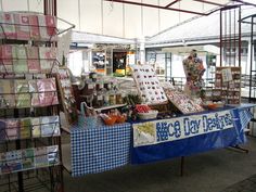 an outdoor market with lots of items for sale on the table and in front of it