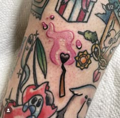 a close up of a person's leg with tattoos on it and various things in the background