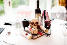 a table topped with wine bottles and a skull