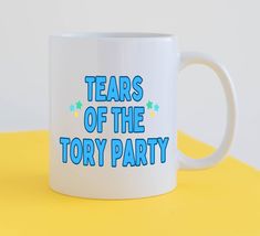 a white coffee mug with the words tears of the story party on it