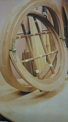 a wooden spinning wheel sitting on top of a table