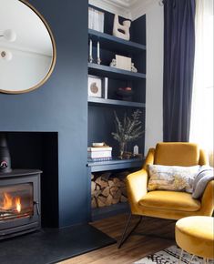 a living room filled with furniture and a fire place in front of a mirror on the wall