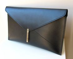 This beautiful leather women's envelope clutch bag is made of black leather. It has a elegant silver color metal closure. Without lining. It is 100 % handmade and designed by me. Main color: Black Material: Black leather Silver color metal closure Measurement: Width 35 cm (~14 inch) Height 20 cm (~8 inch) Please feel free to contact me if you have any questions about this item. Black Envelope Clutch For Formal Occasions, Modern Envelope Clutch For Formal Occasions, Formal Envelope Clutch, Black Envelope Clutch For Office, Elegant Black Envelope Clutch, Modern Envelope Clutch For Office, Leather Envelope Clutch For Office, Leather Envelope Clutch, Envelope Clutch Bag