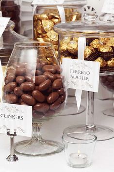 there are many different types of chocolates in the glass bowls on the table together