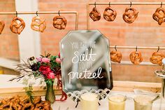 a table topped with donuts and pretzels next to drinks