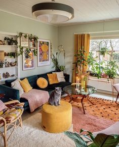 a living room filled with furniture and plants