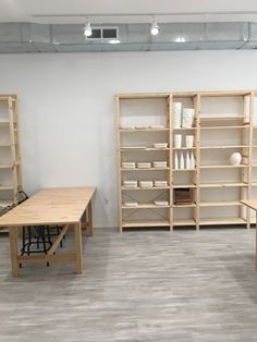 a room filled with wooden shelves and tables