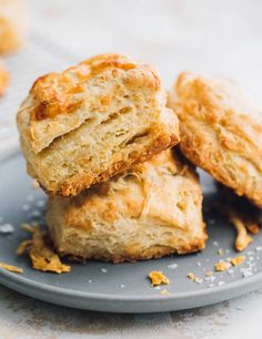 three biscuits stacked on top of each other on a plate with orange zest sprinkles