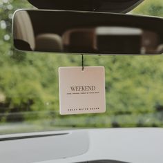 a sign hanging from the side of a car window that reads, weekend is here