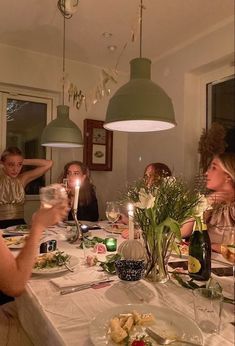 a group of people sitting around a dinner table