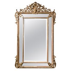 an ornate gold framed mirror on a white background