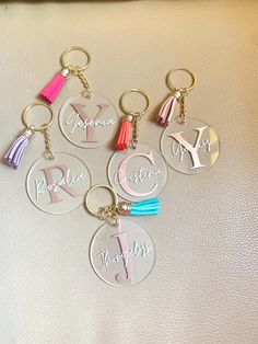 six personalized acrylic key chains with tassels