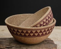 two bowls sitting on top of a wooden table