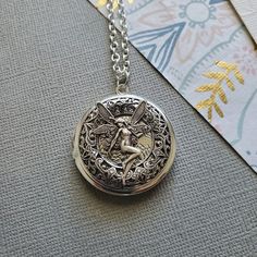 Fairy Gateway Locket Necklace ☻Locket ~ Round Silver ~ With Magical Fairy ~ See Photos for size comparison against American quarter Chain: ~ Silver Plated YOU CHOOSE YOUR CHAIN LENGTH during checkout ☻More Lockets Here: https://www.etsy.com/shop/FashionCrashJewelry/search?search_query=lockets&order=date_desc&view_type=gallery&ref=shop_search ☻Link to The ENTIRE SHOP: https://www.etsy.com/shop/FashionCrashJewelry?ref=shopsection_shophome_leftnav&ga_search_query=crystal%2Bnecklace Silver Fairy Jewelry For Festivals, Silver Fairy Style Jewelry For Festival, Fairy Style Silver Jewelry For Festival, Adjustable Silver Fairycore Jewelry, Handmade Adjustable Fairy Jewelry, Fairy Style Adjustable Jewelry For Gifts, Fairy Style Adjustable Wedding Jewelry, Fairy Pendant Jewelry Gift, Fairy Style Pendant Jewelry Gift