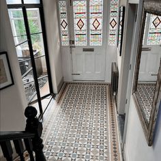 an entryway with stained glass windows and tiled floor