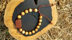 +. God Bless You. +. This is a Wooden Rosary Bracelet. +. It is knotted bracelet and it is adjustable . +. The crufix is carved in elevorate and three dementional shape. +. Beads are not round but beautifully angled. +.+.+.+.+. Materials +.+.+.+.+.+. Cross: Surinam Ebony Beads :olive tree +.+.+.+.+. Size +.+.+.+.+. Cross : 13.3mm(Width) *20mm(Height) Beads: 8mm +. Engraved characters(e.g. baptismal name, name,etc) on back side. It's Free engraving +. please send me characters that you want. +.Wo Handmade Brown Rosary Bracelet As Gift, Adjustable Brown Rosary Bracelet For Meditation, Catholic Rosary Bracelet, Knotted Rosary, Mens Rosary, Wooden Rosary, Knotted Bracelet, Catholic Cross, Light Brown Color