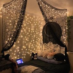 a bedroom decorated with fairy lights and string lights on the walls, along with a bed that has a netted canopy over it