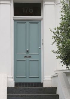 a blue front door with the number seventy on it