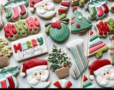 decorated christmas cookies are displayed on a table