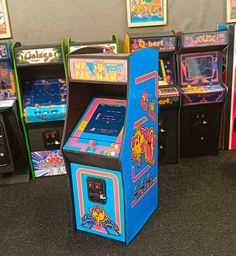 an arcade machine sitting on top of a floor next to other game machines in a room