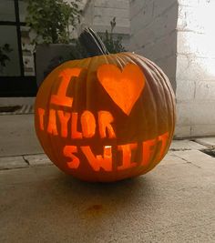 a carved pumpkin with the words taylor swift carved into it's face and heart