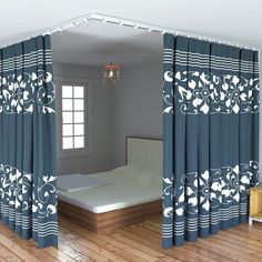 a bed sitting in the middle of a room with curtains on it's sides