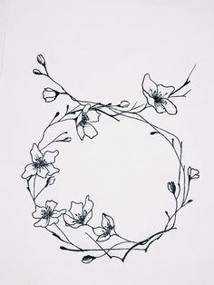 an ink drawing of some flowers on a white paper with black lines in the shape of a circle