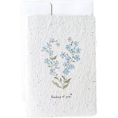 a white card with blue flowers on it and the words love is wonderful written in black ink