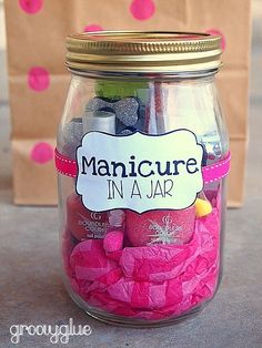 a jar full of manicures on top of a table