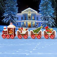 a christmas train with santa's sleigh and gifts in front of a house