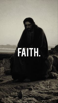 a man sitting on rocks with the words faith written in white across his chest and face