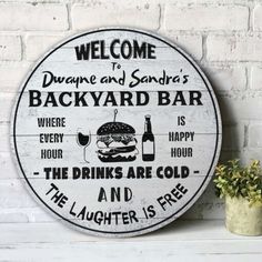 a sign that says welcome to backyard bar and the drinks are cold - the laughter is free