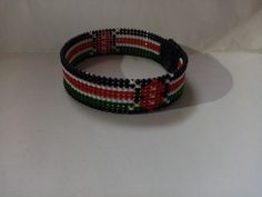 two bracelets made out of beads on a white surface with the colors of the italian flag