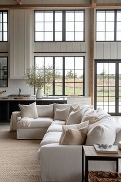 a living room filled with furniture and lots of windows