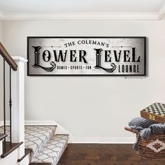 a sign on the wall above some stairs in a house that says, the coleman's tower level lounge