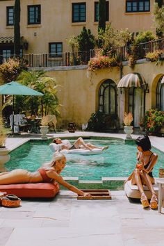 three women lounging around in the pool